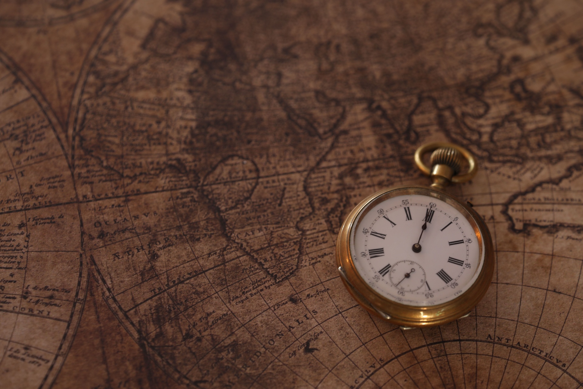 A vintage pocket watch resting on an old map, symbolising time passing in a relationship